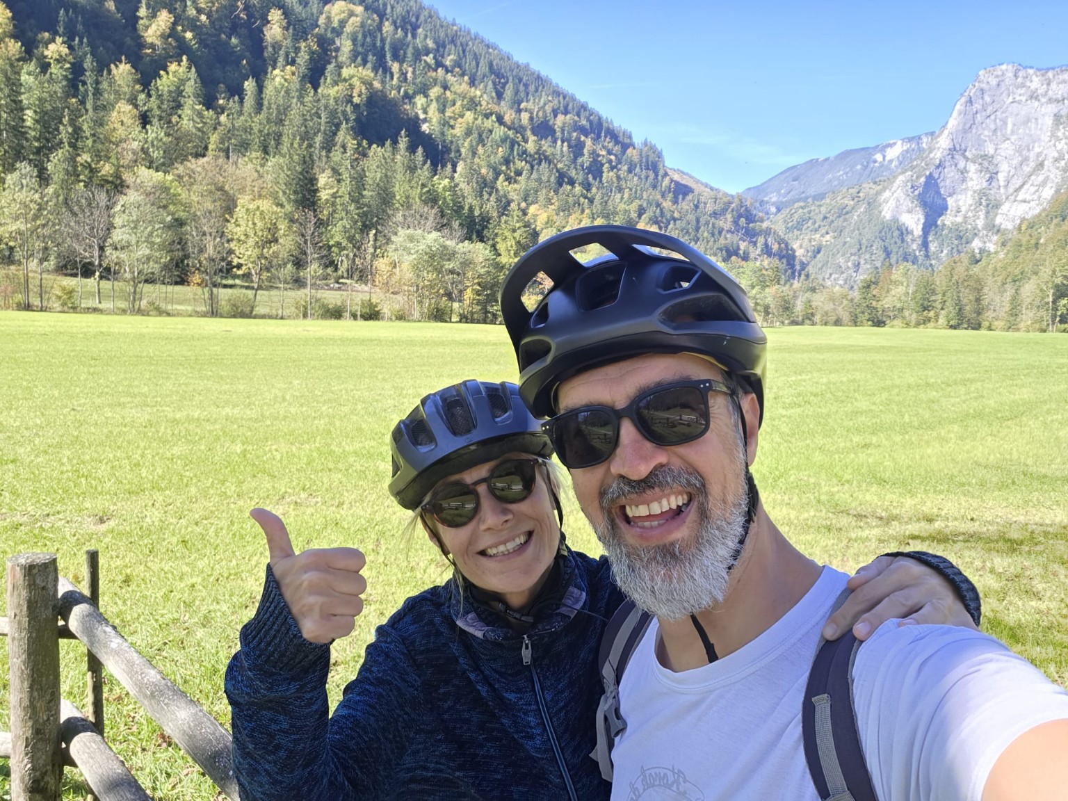 Goran and a companion smiling during a bike ride in the mountains.